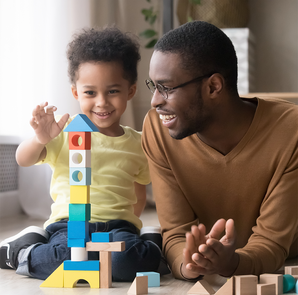 father and daughter playing children's building blocks